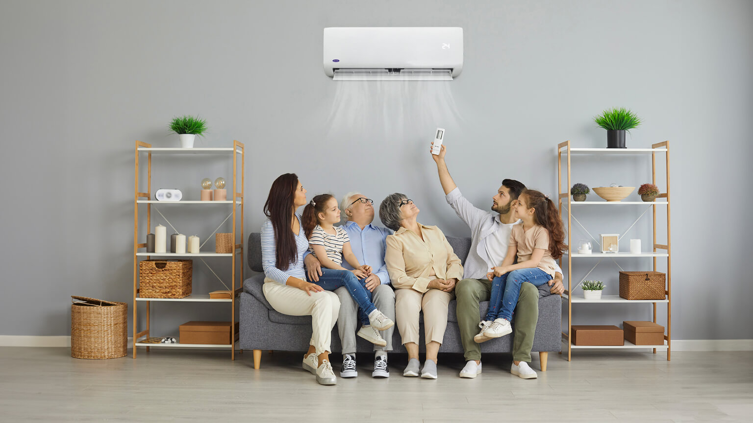 family-sitting-in-the-living-room-while-enjoying-their-Carrier-aircon-unit