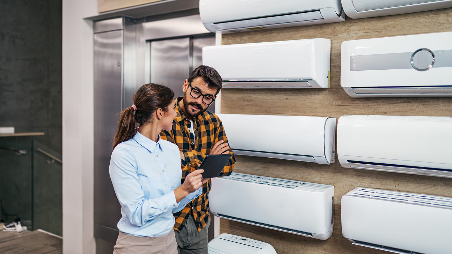 a-lady-and-a-man-inside-an-aircon-unit-store 